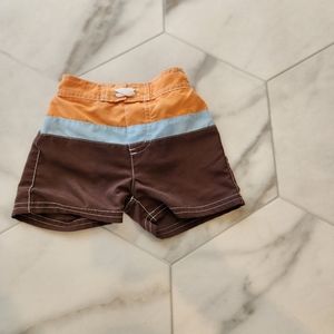 Baby boys size 12.5- 18 pounds orange, blue and brown Bohovibes swimshorts.